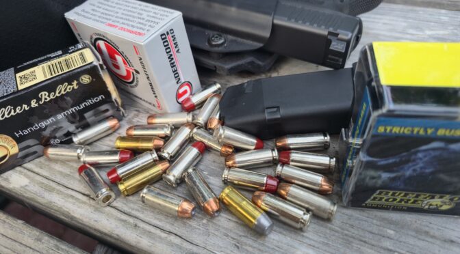 10mm Auto ammunition, including Underwood and Buffalo Bore, with a pistol and holster.
