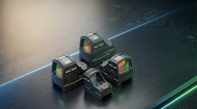 Holosun Technologies optics: A selection of red dot sights on a metallic surface.