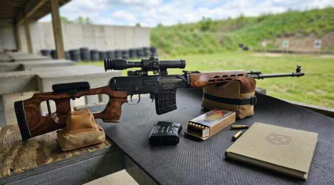 FEG HD18 Dragunov clone rifle with scope on shooting range, ammo and logbook on table.