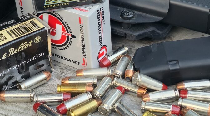 Various 10mm Auto cartridges from Underwood, Buffalo Bore, and Sellier & Bellot ammunition boxes on a wooden surface.