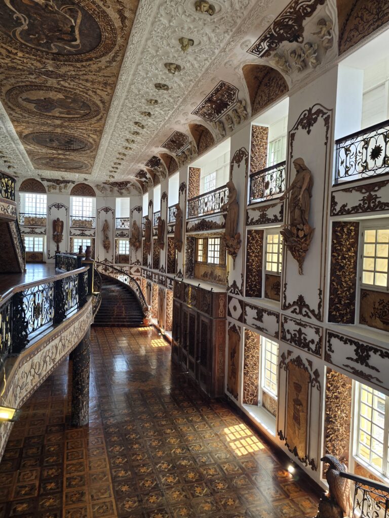 Grand staircase and ornate hall at Las Casas Filipinas de Acuzar, showcasing Filipino heritage.