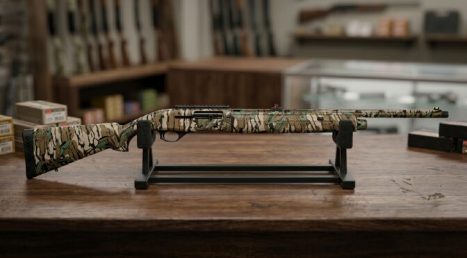 Camouflaged shotgun on display stand in gun shop.