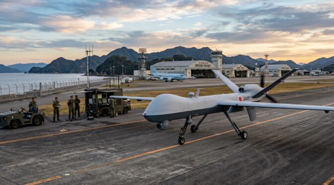 Japan Ground Self-Defense Force MQ-9 Reaper drone on tarmac with personnel and vehicles.