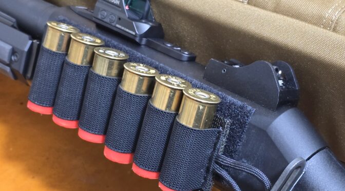 Shotgun with shell holder and Holosun red dot sight.