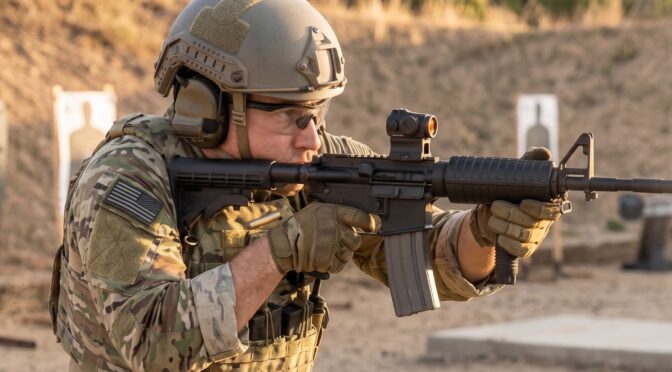 Soldier fires an assault rifle at an outdoor shooting range, with muzzle flash and ejected casings.