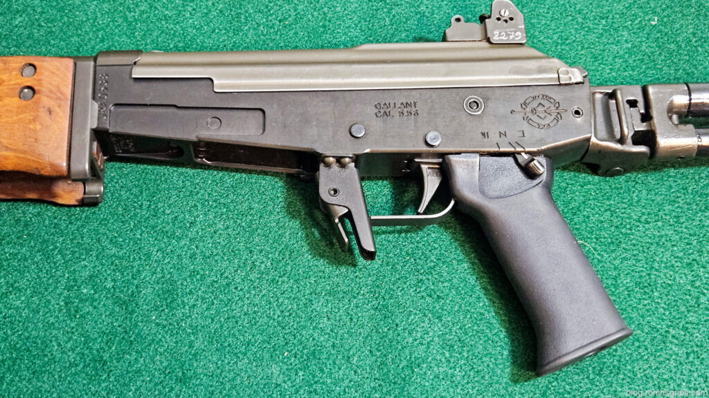 Close-up of a Galil rifle, showing the receiver, trigger, and grip. Text reads "GALIL CAL. 5.56".